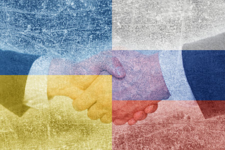 Shaking hands for world peace. Textured photo of the flag of Ukraine and Russia.の写真素材