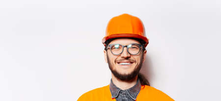 Portrait of happy young man, construction worker on white, with copy space.の写真素材