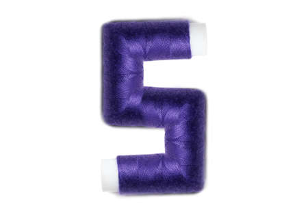 Letter of S from thread spools, isolated on white background. Alphabet concept.