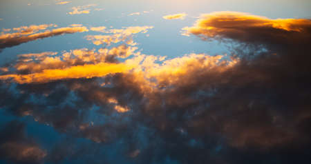 Colourful clouds above blue sky at sunset. Natural landscape. Panoramic banner