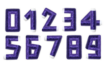Alphabet numbers from thread spools, isolated on white background.