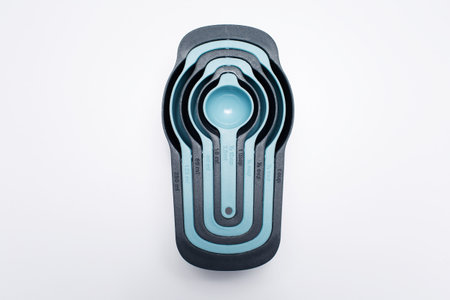 Studio photo of a set of plastic measuring cups, kitchen tools.の写真素材