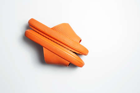Close-up top view of orange slippers isolated on white background.の写真素材