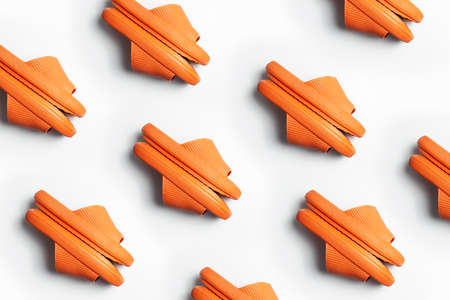 Colourful pattern of orange slippers isolated on white background.