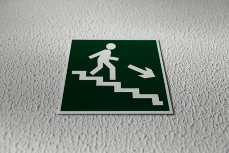 Close-up of exit sign on background of textured wall.の写真素材