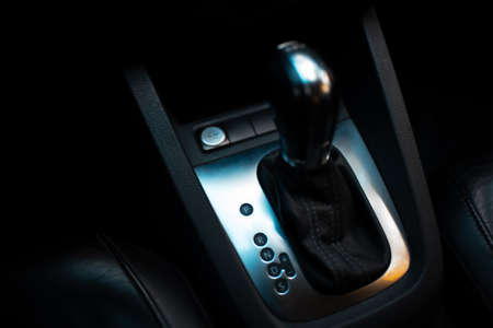 Top view of automatic gearbox selector. Dark photo. Close-up.