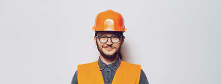 Portrait of young construction worker on white background. Panoramic banner.の写真素材