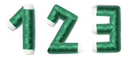 Alphabet numbers of 1, 2, 3 from thread spools, isolated on white background.