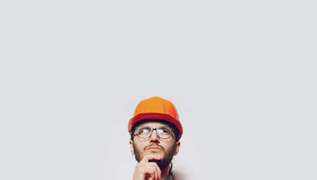 Portrait of young construction worker on white. Panoramic banner, copy space.の写真素材