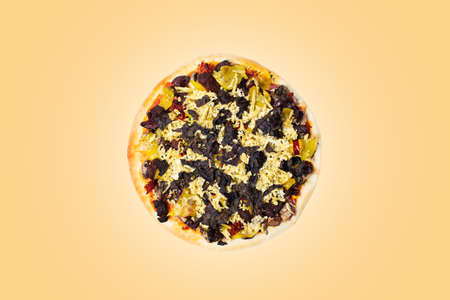 Close-up of vegan pizza isolated on pastel orange background. Top view.の写真素材