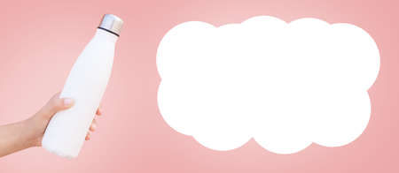 Metal water bottle in hand on pink, copy space, panoramic banner, empty blank speech bubble.の写真素材