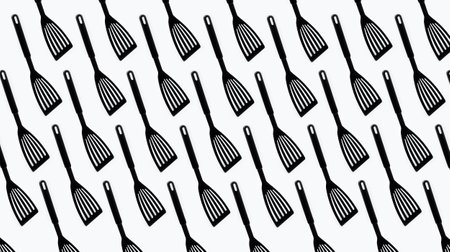 Pattern of black plastic turner spatula on white background.の写真素材