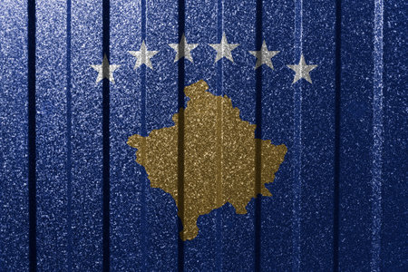 Textured flag of Kosovo on metal wall. Colorful natural abstract geometric background with lines.の写真素材