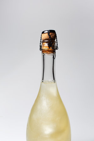 Close-up of champagne bottle on white background. Unusual cocktail drink.の写真素材