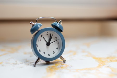 Close-up of blue alarm clock on table.