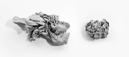 Crumpled paper ball of beige color isolated on white background. Black and white.の写真素材