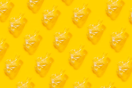 Pattern of crumpled plastic bottles on yellow background. Photo collage.の写真素材