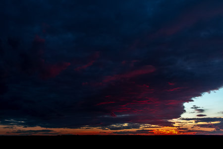Natural landscape of beautiful sunset with very dark clouds.