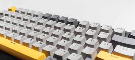 Mechanical keyboard for computer on white background. Key cap of grey, black and yellow colours.の写真素材