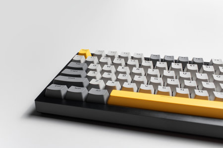 Mechanical keyboard for computer on white background. Key cap of grey, black and yellow colours.の写真素材