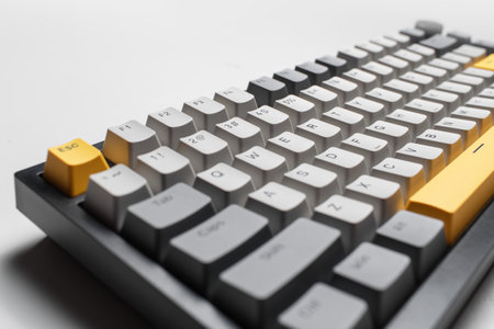 Mechanical keyboard for computer on white background. Key cap of grey, black and yellow colours.の写真素材