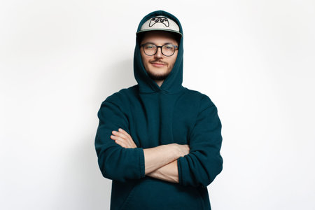 Young man wearing hoodie sweater, cool cap and eyeglasses. Isolated on white background.