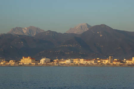 View of the city of Viareggio at the foot of the Apuan Alps, sea in the foreground, Viareggio locality, Tuscany, Italyの写真素材