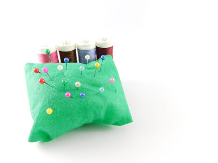 Pins on pillow with threads behind.の写真素材
