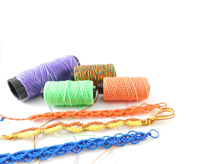 Yarns of different colors and bracelets made by hand.の写真素材