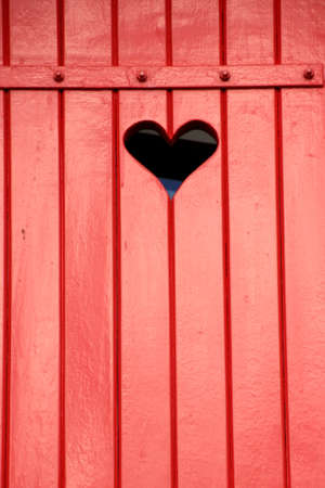 Red, wooden shutter with a heartの写真素材