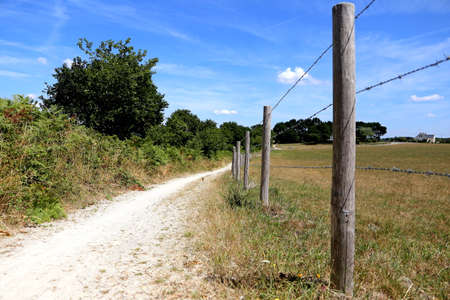 Walking along a field in rural brittanyの写真素材
