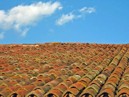 roof with red tiles and blue skyの写真素材