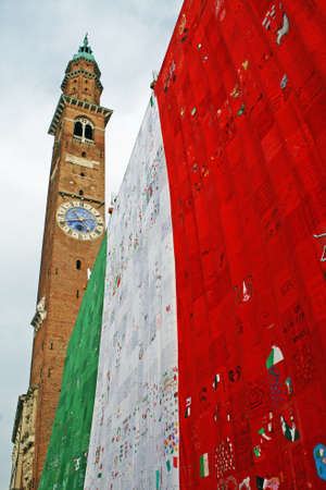 bell tower in Piazza dei Signori Vicenza  with  Italian flag on  anniversary of  unit of Italyの写真素材