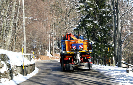 truck with Snowplow and spread salt on the iceのeditorial素材