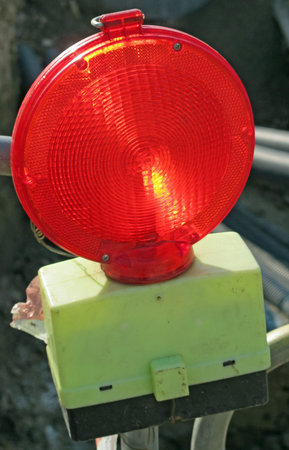 red light to signal a road construction site at night 