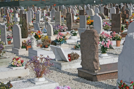 graves  headstones and crucifixes of a cemetery outdoor in Italy