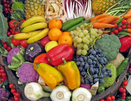 basket full of grapes, peppers, cabbage, carrots, radish, pineapple