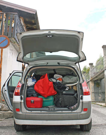 Family car ready to go with the trunk full of suitcases and bagsの写真素材