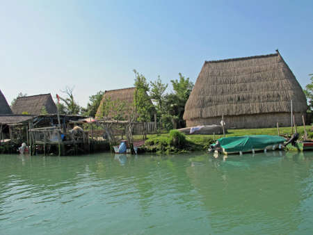 old huts and piles of straw and wood where they dwelled fishermenのeditorial素材