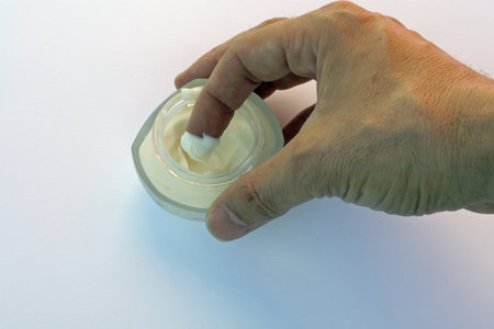 index of a hand of an adult who takes a bit of cream