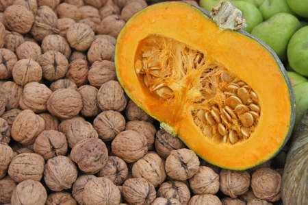 half pumpkin with walnuts and green pears ripe for sale to the marketの写真素材