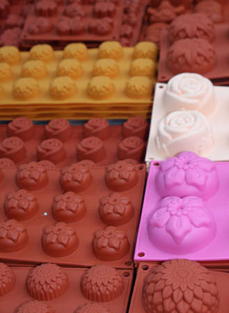 Brown and purple silicone molds for sale at a market stallの写真素材