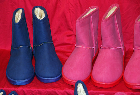 Blue and pink boots for sale at the market