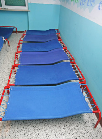 Blue camp beds and little beds for sleeping in a dormitory ofa  nursery school for children
