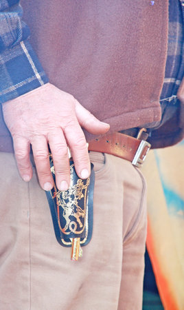 gun-toting cowboy's hand before the challenge at the last blood