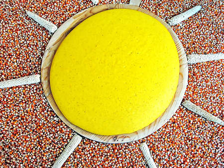 yellow polenta with sun shaped seeds of cornの写真素材