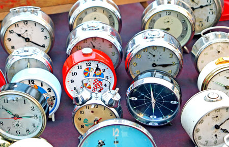 ancient clocks and watches from table in an antique market