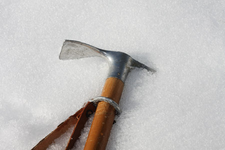 Toy axe stuck in the cold snow in the mountains in winterの写真素材