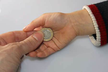 parent who delivers a Greek euro tip to her young daughterの写真素材