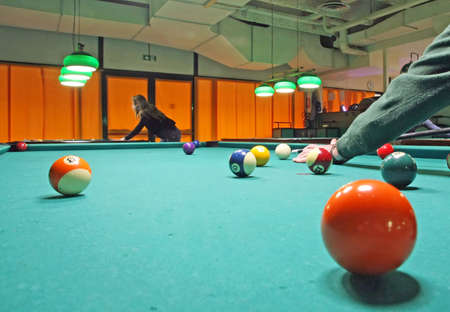 smoky poolroom with marbles on the carpet and attentive playersのeditorial素材